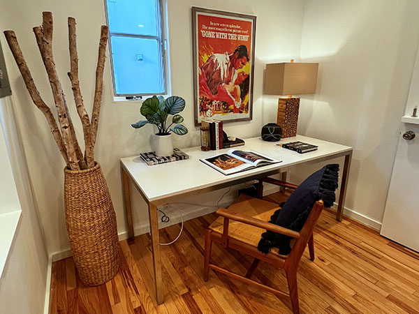 Home staged space with desk and chair on wood flooring.