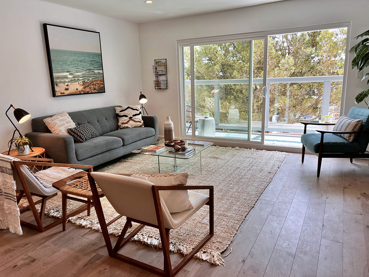 Room with sliding glass door and seating.